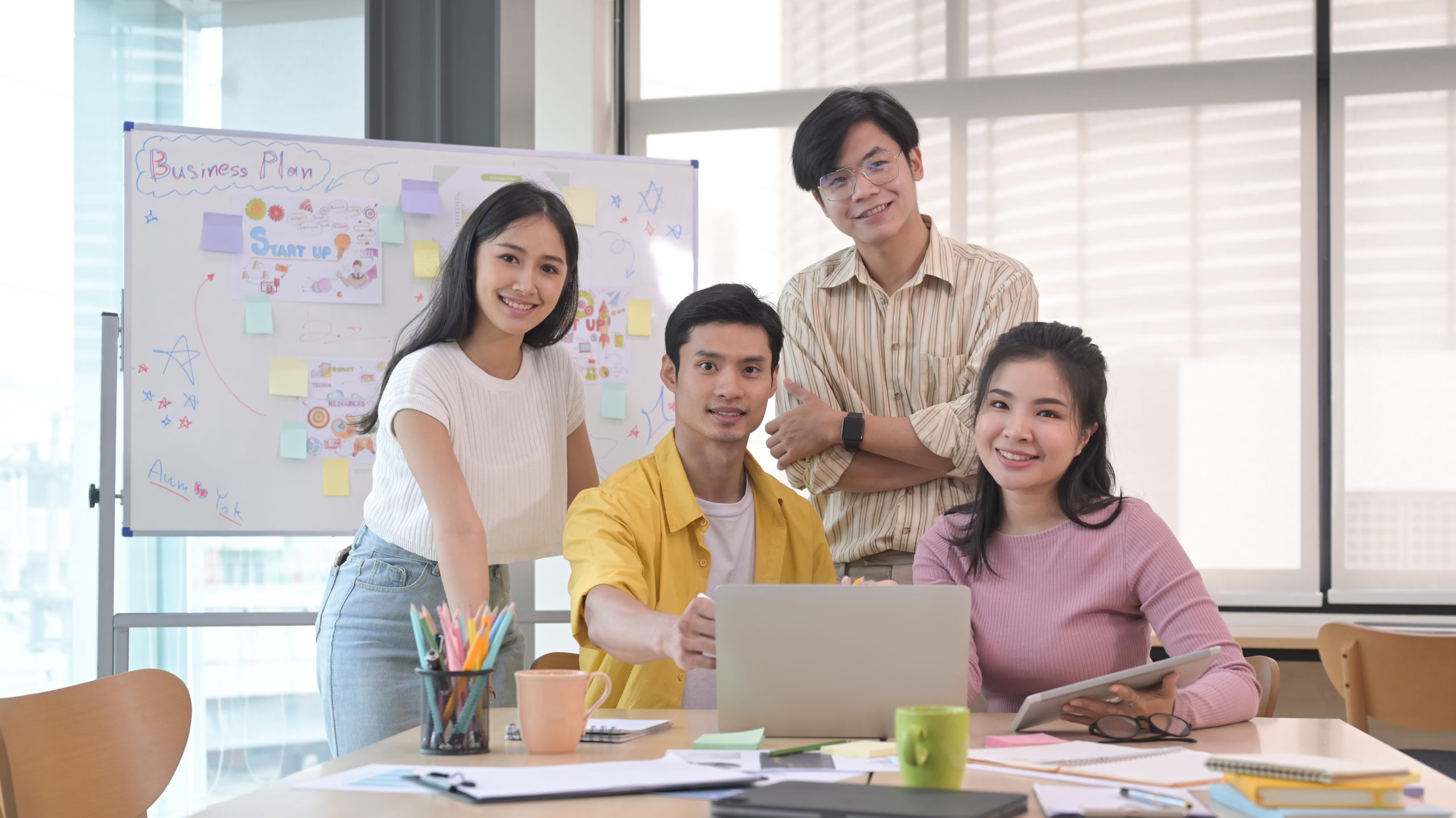 Successful business team gather in boardroom and smiling posing